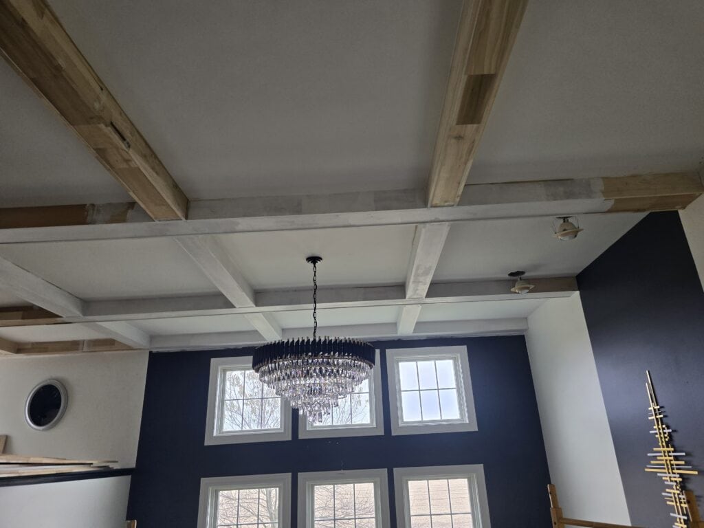 Coffered ceiling installation in Lewis Center, OH featuring poplar beams, crown molding, and premium painted finish by PaintWerks.