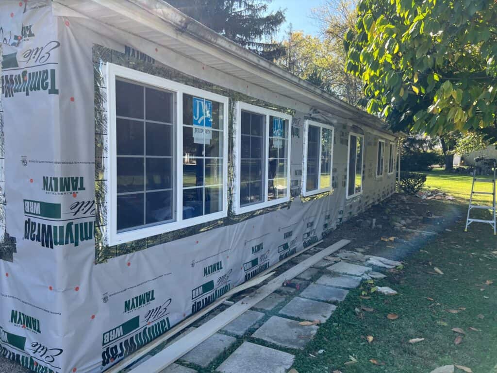 Exterior rebuild in Worthington, Ohio with new framing, sheathing, windows, and LP SmartSide board and batten siding installed by PaintWerks.