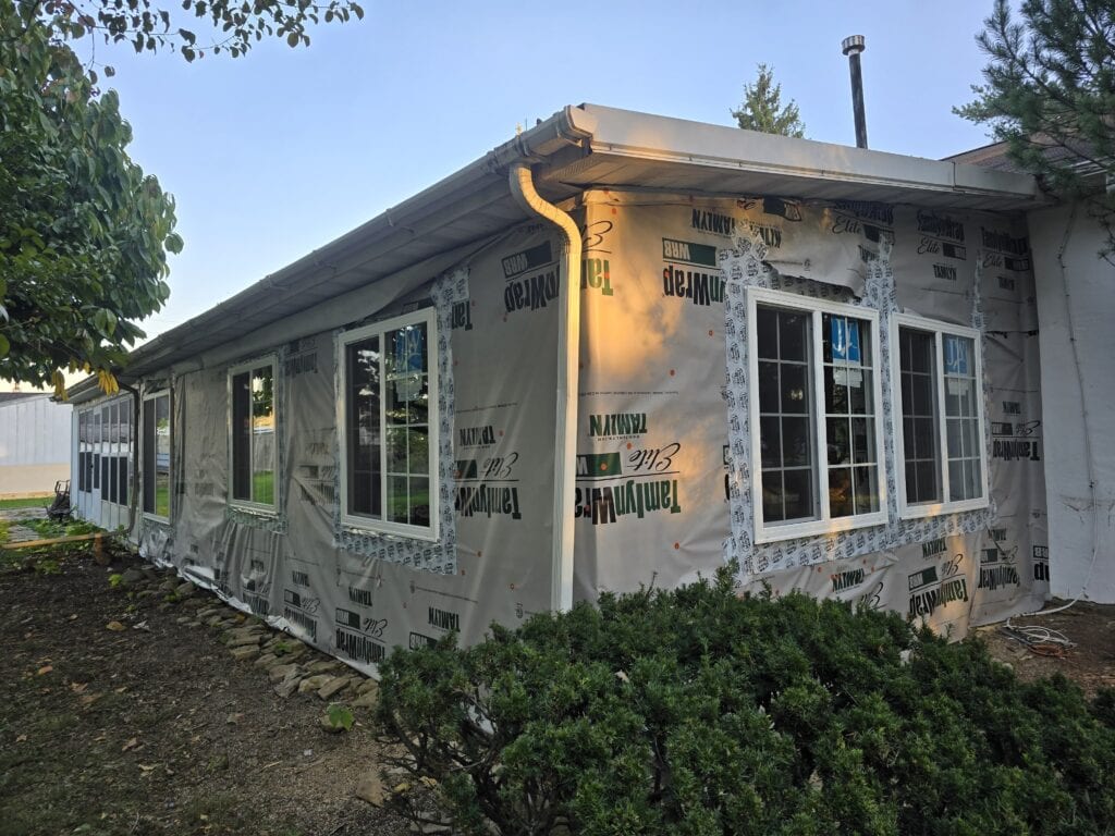 Exterior rebuild in Worthington, Ohio with new framing, sheathing, windows, and LP SmartSide board and batten siding installed by PaintWerks.