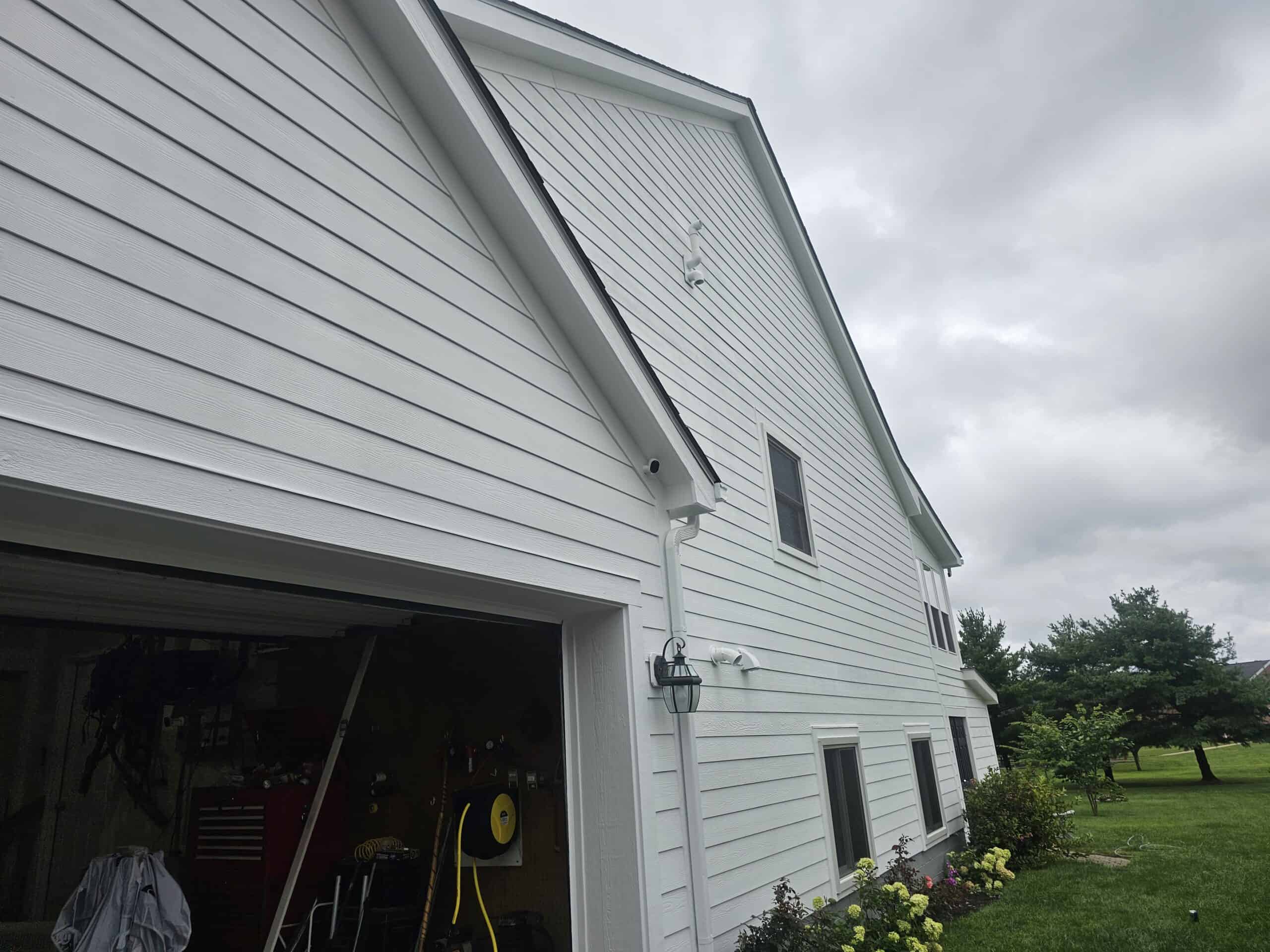 Bright white siding looks fresh and new after professional painting.