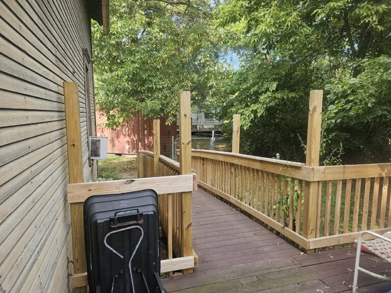 Highly detailed image of a freshly constructed wooden deck with safety railing in a backyard.