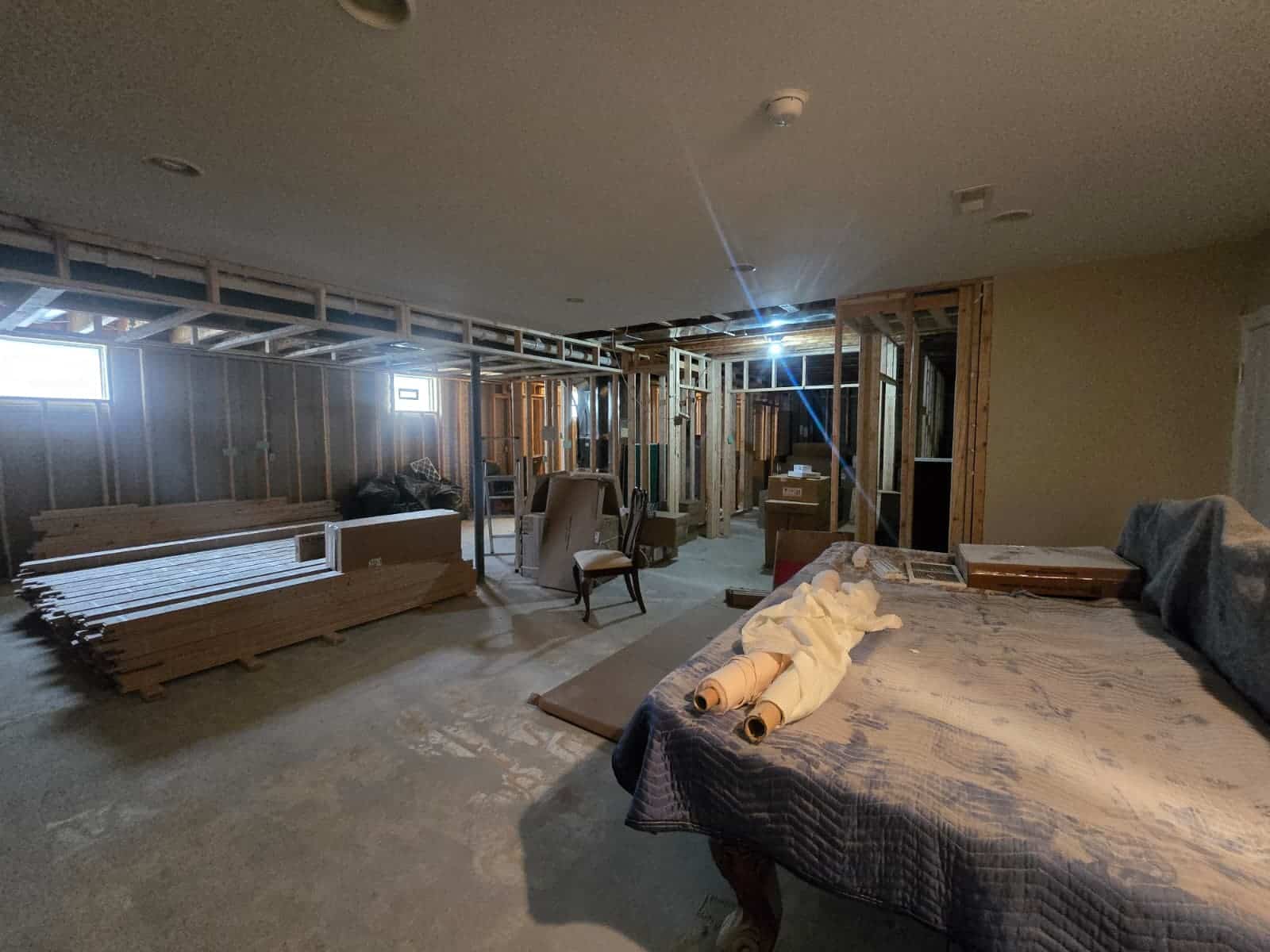 Interior home remodeling with exposed drywall framing, visible wood studs, and ongoing construction in Columbus.