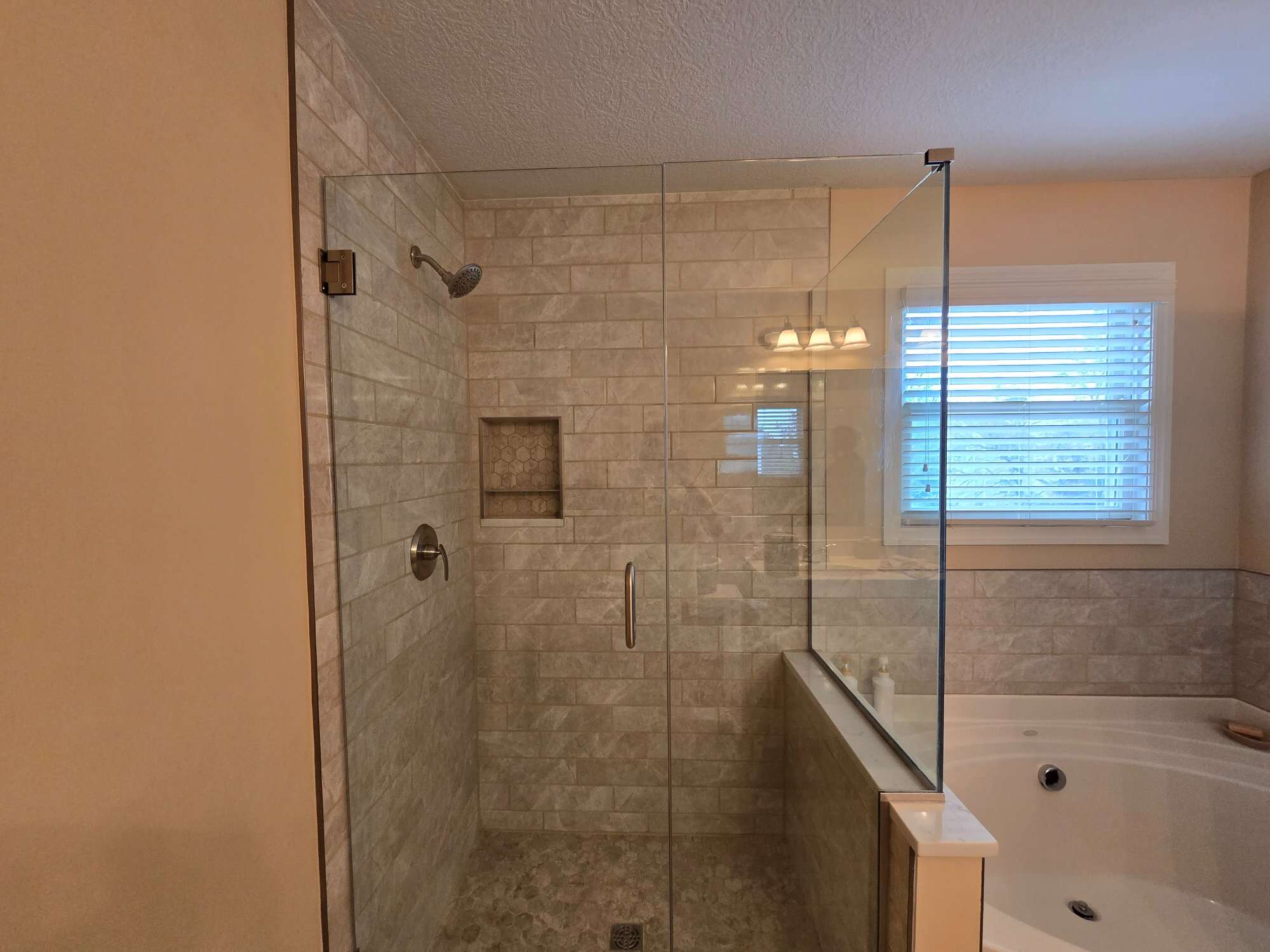 Completed master bath shower remodel custom tile niche semi-frameless glass hexagon floor Lewis Center Ohio