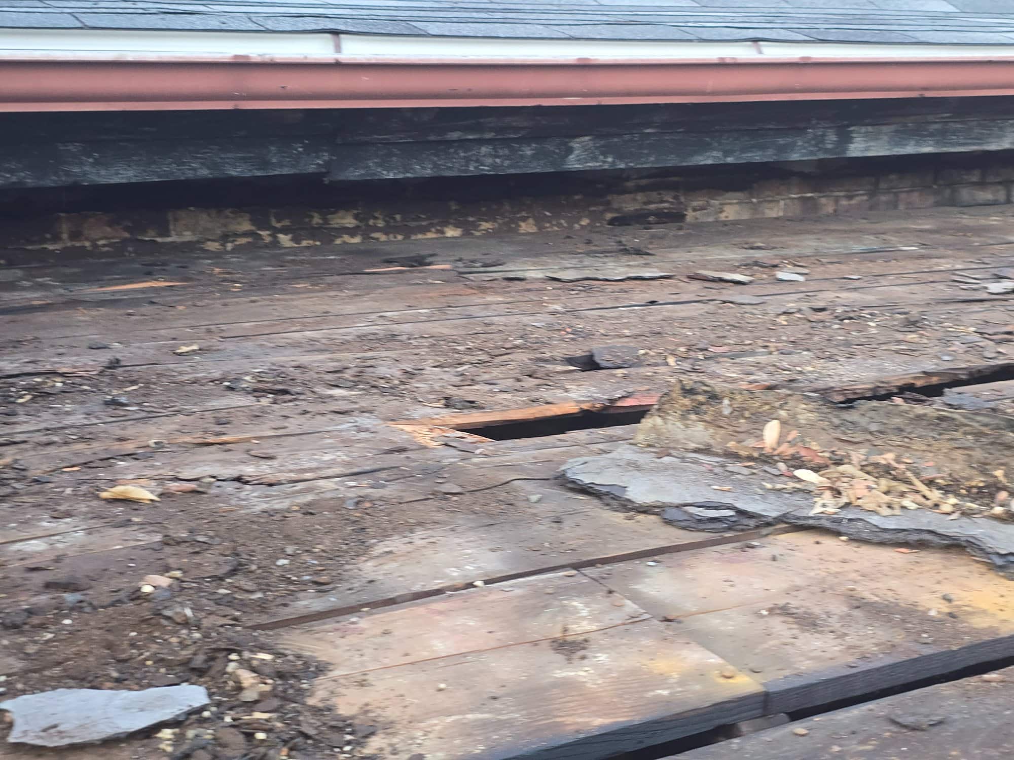 Rotted porch roof decking close-up copper gutter 90 E Lincoln St Columbus OH